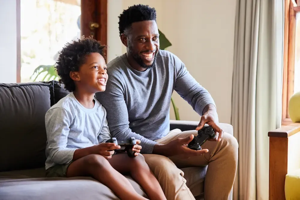 father and son playing video games